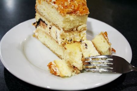 Cake with a piece broken off, on a white plate