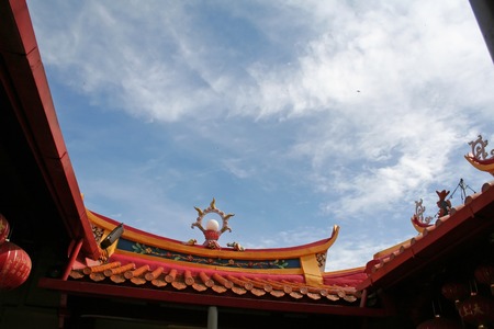 Traditional chinese temple rooftop against blue skyの写真素材