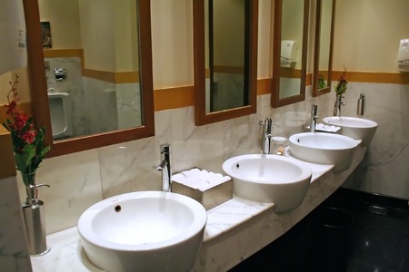 Modern washroom with round ceramic sinks