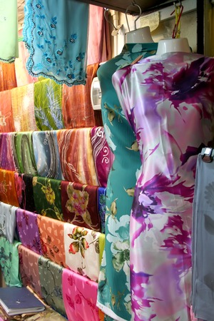 Traditional asian fabrics and clothes for sale in a shop in Malaysiaの写真素材
