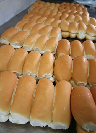 Rows of bread loaves in racks in a bakery