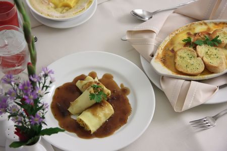 Room service food presentation with hotel bed in backgroundの写真素材