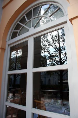 Elegant window looking into restaurant pink wall