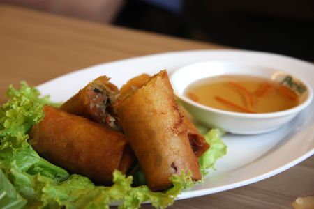 Fried vietnamese spring rolls with traditional greens