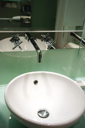 Elegant modern steel and glass faucet sink in bathroomの写真素材