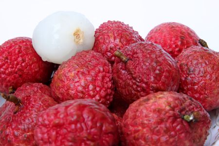 Lychee fruits fresh whole pile unpeeled and peeled