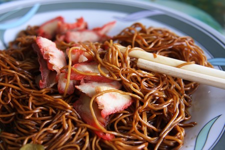 Traditional chinese noodle dish with soy sauce and sliced meatの写真素材