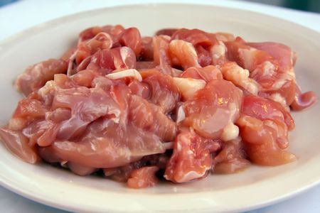 Raw chopped chicken meat on white plateの写真素材