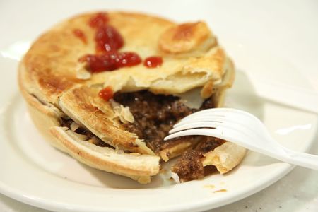 Australian beef pie, broken with meat stuffingの写真素材