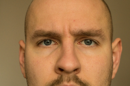 close up of the men's face with blue eyes and faint mustacheの写真素材