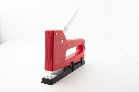 Red Stapler Gun.shoot on white background. Useful for office and household. Manage and combine document.の写真素材