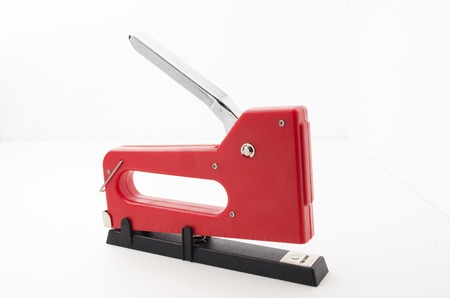 Red Stapler Gun.shoot on white background. Useful for office and household. Manage and combine document.の写真素材
