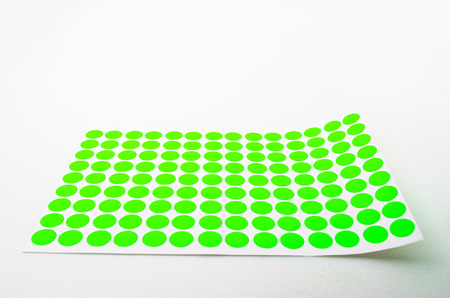 Yellow Small Circular Stickers. Shoot on white background. Focus on the closes distance. Can be use for office and school works.の写真素材