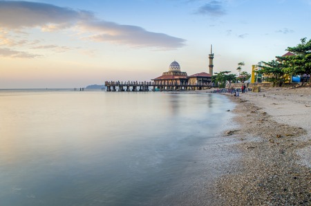 Malaysian mosque located in Perlis Malaysia, named Masjid Al-Hussein, also called floating mosque. This is a beautiful places for tourist. The sunset is behind the mosque from the front view.の写真素材