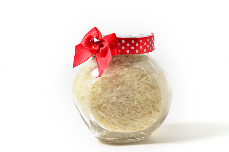 Rice in a glass container. Shoot over white background. Shallow depth of field. Focus on the important part.の写真素材