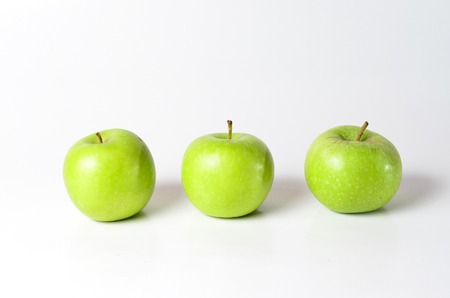 Green Apples shoot over white background. Shallow depth of field. Focus on the closes distance.の写真素材