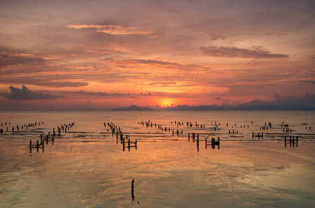 Landscape of Ocean with rock foreground on Sunsetの写真素材