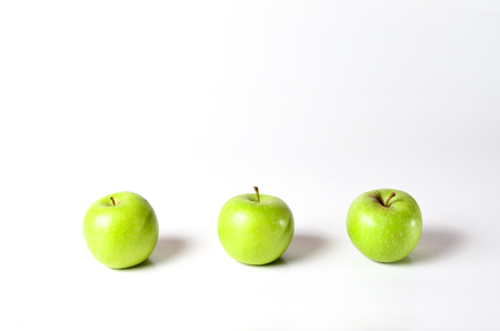 Green Apples shoot over white background. Shallow depth of field. Focus on the closes distance.の写真素材
