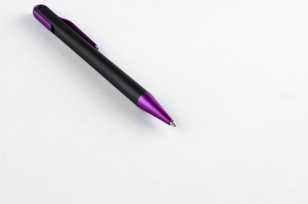Purple and black pen on white backgroundの写真素材