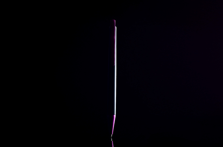 Purple pen on black backgroundの写真素材