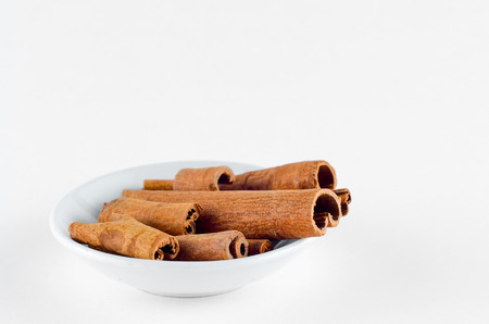 Cinnamon Spice in bowl over white backgroundの写真素材