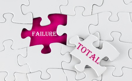 Business Concept - White puzzle with reddish purple void in the middle when one piece of the puzzle is taken out with word Total Failureの写真素材