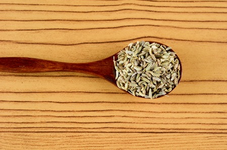 Aniseed Spice in wooden spoon over wooden backgroundの写真素材