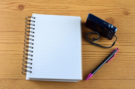 Office desk with  ring book, pen, and camera conceptの写真素材