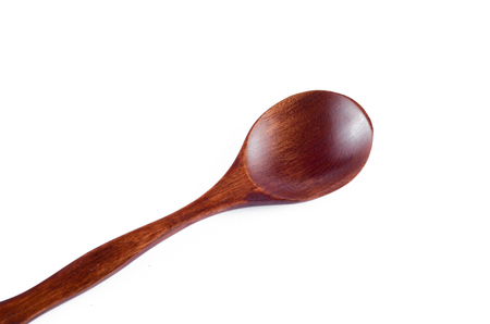 Wooden spoon over white backgroundの写真素材