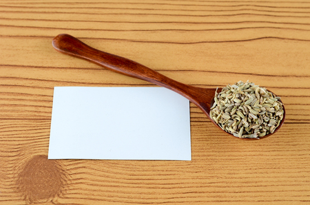 Aniseed Spice in wooden spoon over wooden backgroundの写真素材