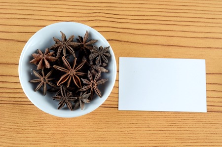 Anise Spice in white bowl over wooden backgroundの写真素材