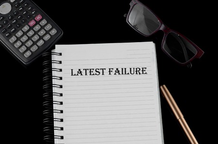 Business concept - Office table with equipment and text written Latest Faillureの写真素材