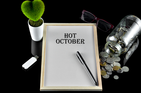 Business concept - Office table with equipment and text written Hot Octoberの写真素材