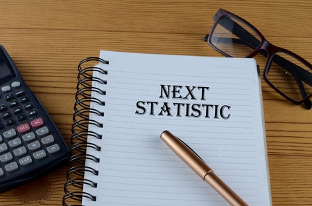 Business concept - Office table with equipment and text written Next Statisticの写真素材