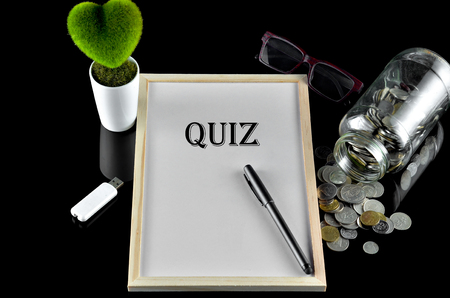 Business concept - Office table with equipment and text written Quizの写真素材