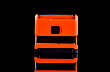 Orange Office stamp on black background with reflectionの写真素材