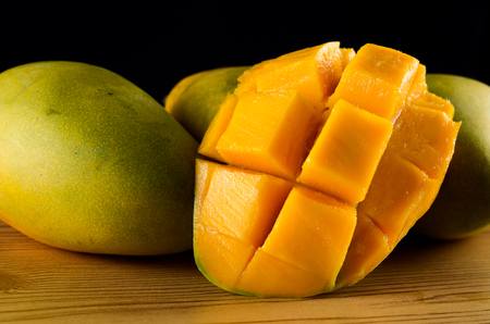 Ripe Mango over wooden backgroundの写真素材