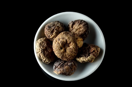 Dried Shiitake Mushroom also known as Haiko Mushroom or Lentinus edodes or  Agaricus edodes over black backgroundの写真素材