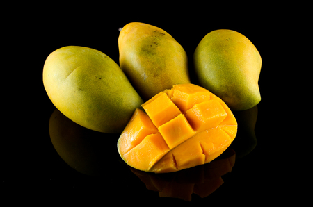 Ripe Mango over black backgroundの写真素材