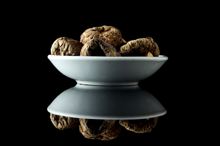 Dried Shiitake Mushroom also known as Haiko Mushroom or Lentinus edodes or  Agaricus edodes over black backgroundの写真素材