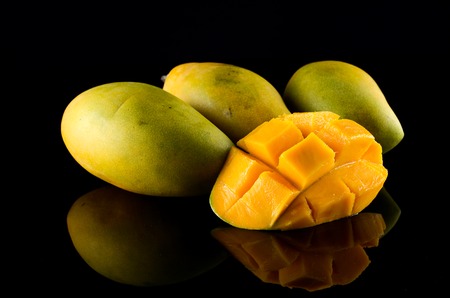 Ripe Mango over black backgroundの写真素材