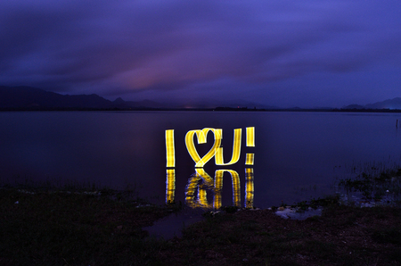 Light painting at night with word I Love You