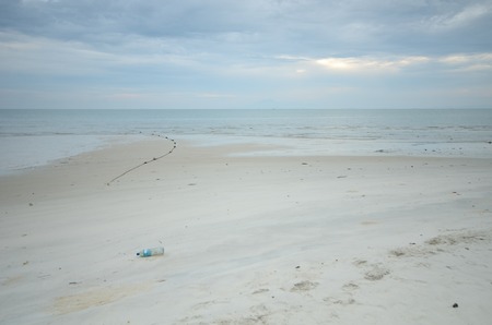 Plastic bottle and fishing net on beautiful Beach