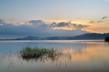 Beautiful lake view on sunset. With water, mountain and cloudの写真素材