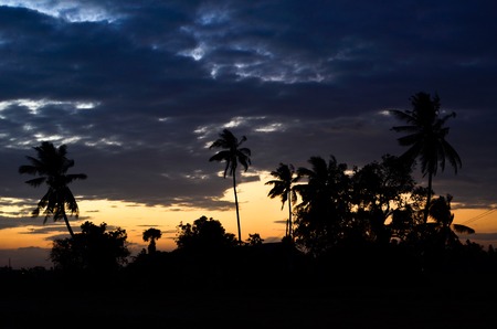 Silhouette of a village over sunsetの写真素材