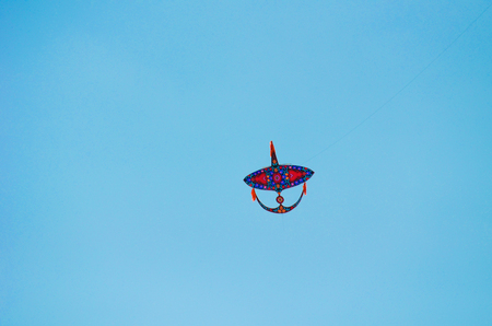 Close view of kite flying in blue skyの写真素材