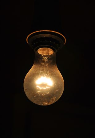 a beautiful light bulb on black backgroundの写真素材