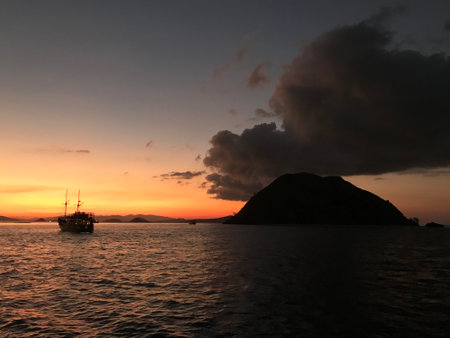 Sunset in the sea with boats and islands in the background.の写真素材