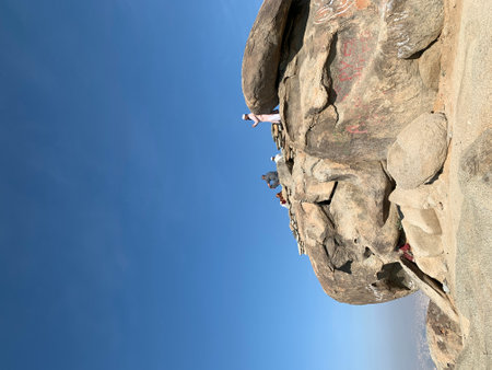 Rock climber climbing on a cliff with blue sky in the background