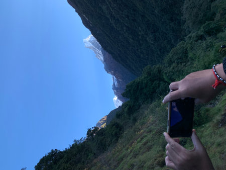 Taking a photo of the mountain landscape with a smart phone in the mountains